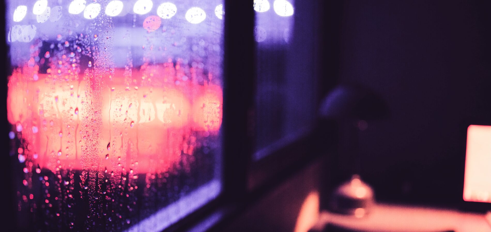 City lights blurred into pink and red bokeh after midnight
